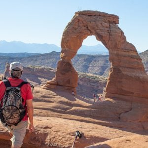 man looking at Delicate Arch